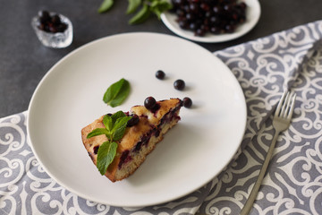 Pieces of delicious homemade cake with berries and mint