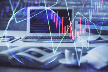 Financial market graph hologram and personal computer on background. Multi exposure. Concept of forex.