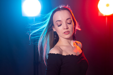 Portrait of young sexy woman with flashes on background