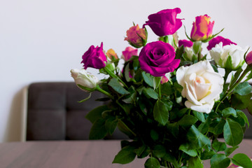 purple bouquet of roses on the table at home