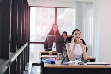 Portrait of young smiling businesswoman working in the office