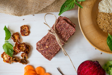Ukrainian Crispbread  with beetroot and tomato. Healthy diet food. Bread cakes on a white background in the ingredient seasoning.