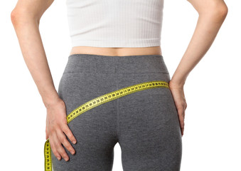 Woman measuring her body. Girl measuring her butt and hips isolated on a white background. Healthy...