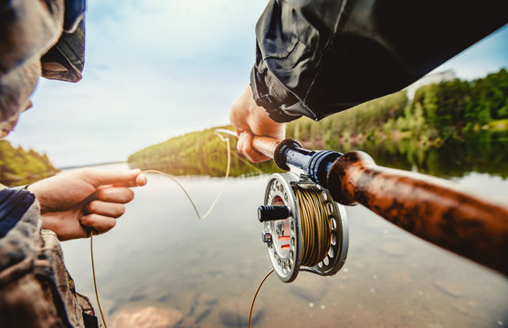 A Fisherman with a Spinning Rod To Catch Fish. Sunglasses and Fishing  Clothes Stock Photo - Image of angling, angler: 114305208