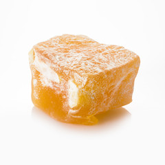 Turkish delight. Pistachio rahat locum with nuts, one piece of sweet oriental delights in powered sugar. Close-up view.