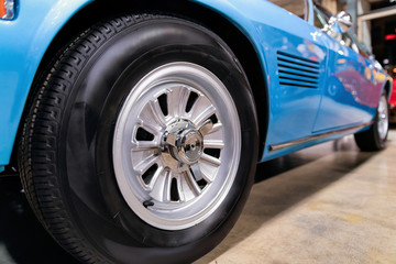 Fototapeta na wymiar Wheel of blue vintage classic car auto