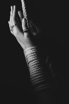 Kinbaku women's hands tied with rope