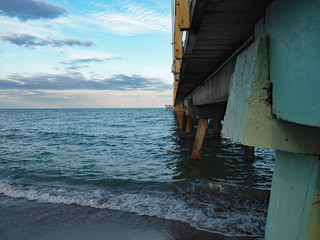turquoise water under pier at the beach in Lauderdale Florida, tropical paradise