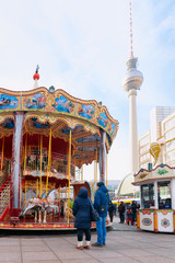 Carousel with kids on Christmas market in Berlin on Alexanderplatz