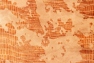 Snakeskin pattern on genuine leather close-up, imitation of exotic reptile, surface of beige brown...