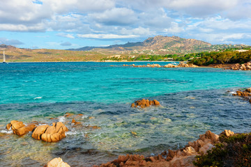 Romantic sunny sunrise at Capriccioli Beach in