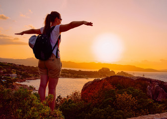 Sunrise or sunset and young lady at Baja Sardinia