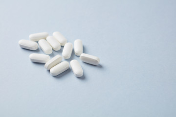 Lysine tablets. Concept for a healthy dietary supplementation. Nervous System Support. Bright background. Close up. Copy space.  