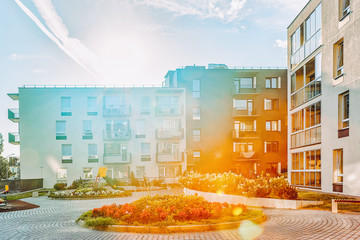 Modern apartment residential buildings children playground at sunset