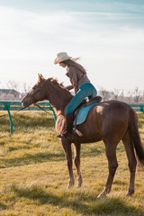 Woman sitting  horse. Day.