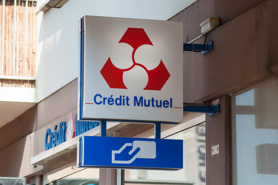 Colmar - France - 24 August 2019 - Closeup of Credit mutiuel sign on bank agency facade in the street