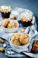 Pumpkin cookies with cups of coffee and marshmallow