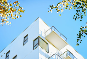 Facade of modern apartment house copy space green tree