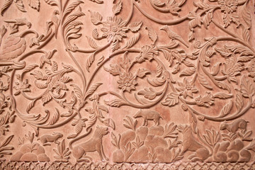 Fototapeta na wymiar Ancient stone bas-relief with flowers and animals in Junagarh fort in Bikaner, Rajasthan, India
