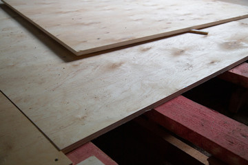 Plywood ,building material. Production of plywood floor. Installation of plywood on the floor.