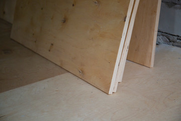 Plywood ,building material. Production of plywood floor. Installation of plywood on the floor.