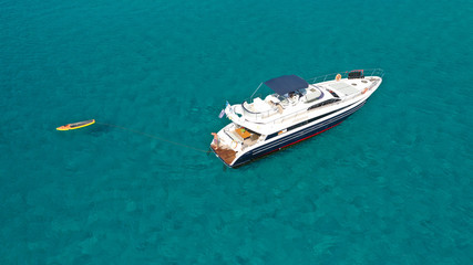 Fototapeta premium Aerial drone photo of luxury yacht docked in tropical Caribbean bay with turquoise open ocean sea