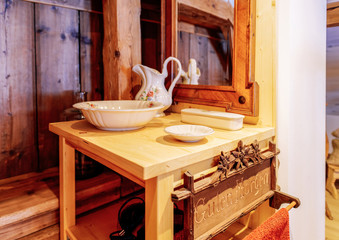 Fototapeta na wymiar Interior of bedroom with mirror table ceramic dishes