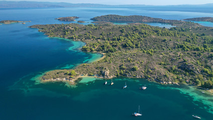 Aerial drone photo of turquoise bay near famous Vourvourou and Diaporos island, Sithonia peninsula,...