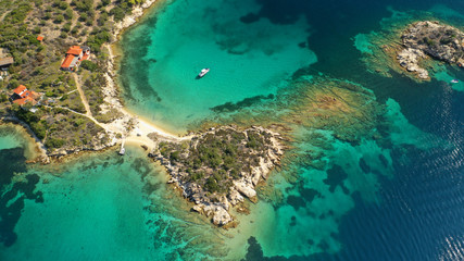 Aerial drone photo of turquoise bay near famous Vourvourou and Diaporos island, Sithonia peninsula, Halkidiki, North Greece