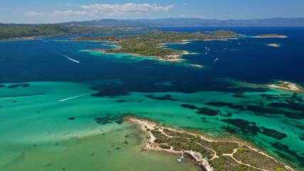 Fototapeta na wymiar Aerial drone panoramic photo of iconic bay with turquoise frozen waves of Vourvourou in Sithonia Peninsula, Halkidiki, North Greece
