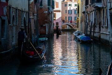 Fototapeta na wymiar Venezia (Venice), Italy. 2 February 2018. Gondolas and boats on the rivers of Venice.