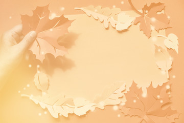 Maple and oak leaves on paper background with shadows and copyspace. Creative handmade paper craft, flat lay, Autumn paper background.