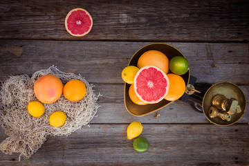 Top view Fresh citrus fruits in vintage scale and several oranges, lemons, grapefruit, lime on the...