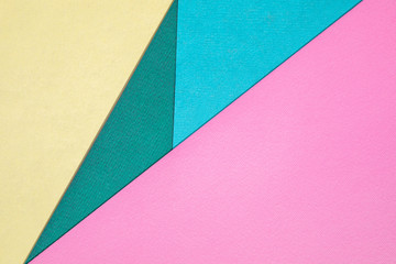 Abstract different pastel colored paper backgrounds with place for text. Diagonal geometric composition. Top view.