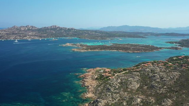 View from above, stunning aerial view of the Maddalena Archipelago National Park with some islands surrounded by a beautiful turquoise clear sea, Caprera island in the distance. Sardinia, Italy.