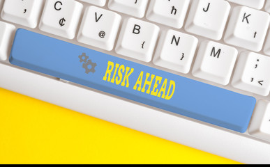 Text sign showing Risk Ahead. Business photo text A probability or threat of damage, injury, liability, loss White pc keyboard with empty note paper above white background key copy space