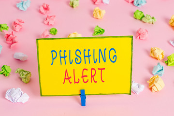 Word writing text Phishing Alert. Business photo showcasing aware to fraudulent attempt to obtain sensitive information Colored crumpled papers empty reminder pink floor background clothespin