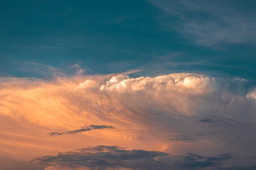 Fototapeta na wymiar Blue sky and cumulonimbus clouds with golden light of sunset. Outdoors beautiful background on summer.