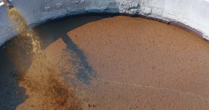 Aerial view of a pipe is pumping organic cow  manure compost  used for agricultural soil cultivation and for biogas, renewable sources of energy.