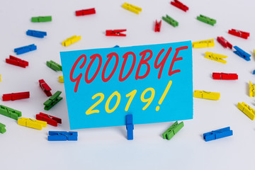 Text sign showing Goodbye 2019. Business photo text express good wishes when parting or at the end of last year Colored clothespin papers empty reminder white floor background office