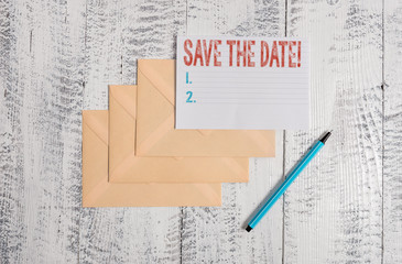 Text sign showing Save The Date. Business photo showcasing remember not schedule anything else on this day Three envelopes marker ruled paper sheet old wooden vintage background