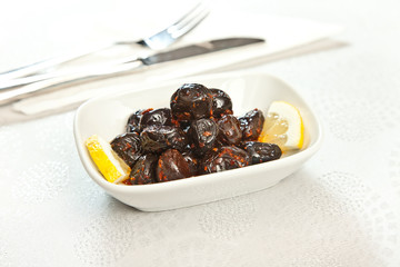 olives on plate on white background