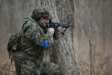 Active military exercises in the forest. Shootout army in the autumn forest. Training airsoft teams in Russia.