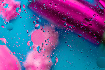 Micro molecular abstract pattern of colored oil bubbles on water. 