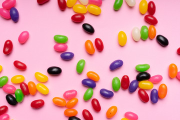 colourful jelly beans candies pink background Top view