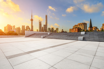 Empty square floor and modern city scenery at sunrise in Shanghai,China.