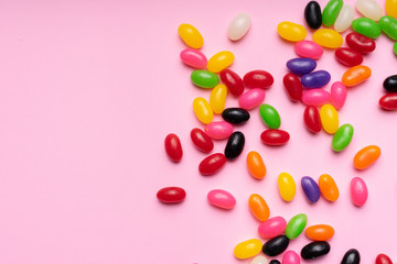 colourful jelly beans candies pink background Top view