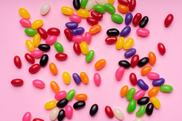 colourful jelly beans candies pink background Top view