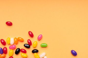 colourful jelly beans candies orange background Top view