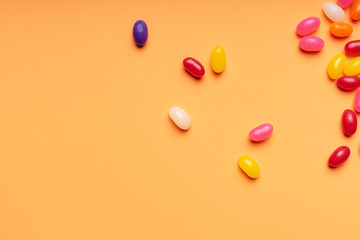 colourful jelly beans candies orange background Top view